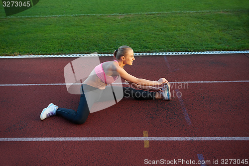 Image of sporty woman on athletic race track