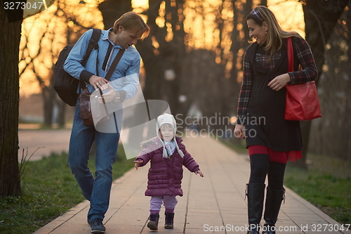 Image of young pregnant couple have fun and relax