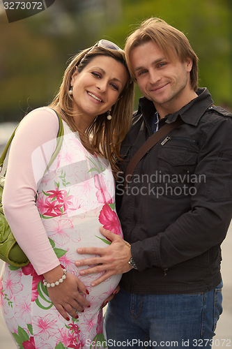Image of young pregnant couple have fun and relax