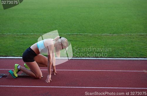 Image of athlete woman group  running on athletics race track