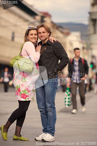 Image of young pregnant couple have fun and relax