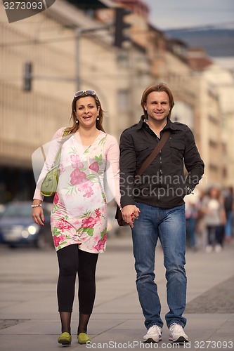 Image of young pregnant couple have fun and relax