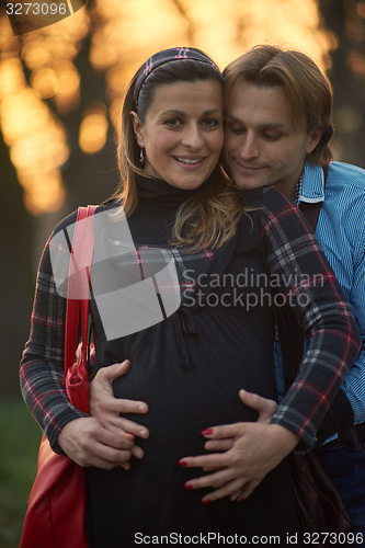 Image of young pregnant couple have fun and relax