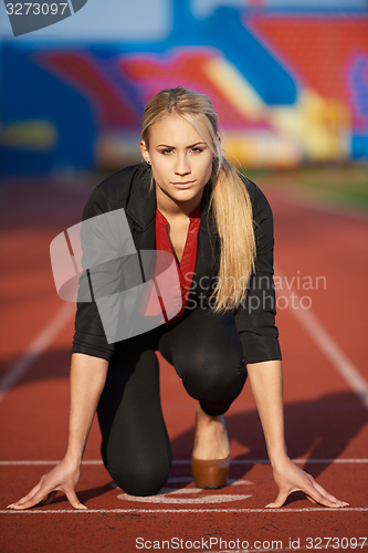 Image of business woman ready to sprint