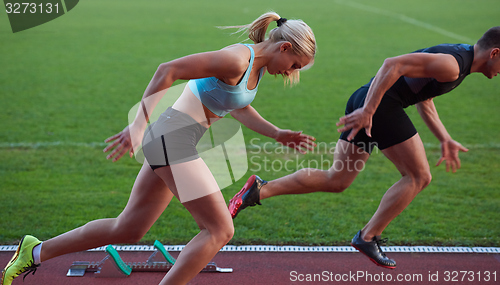 Image of athlete woman group  running on athletics race track