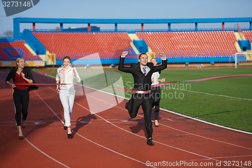 Image of business people running on racing track