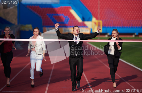 Image of business people running on racing track