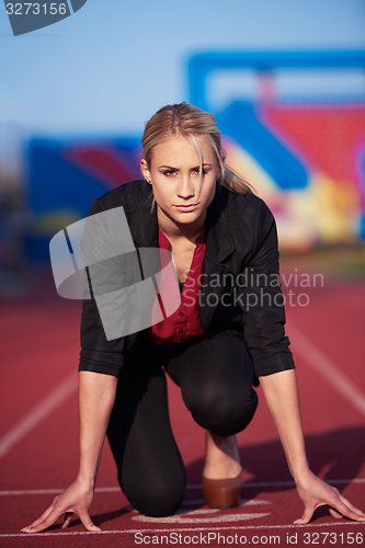 Image of business woman ready to sprint