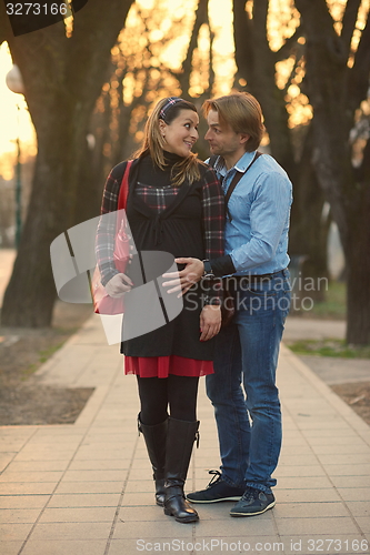 Image of young pregnant couple have fun and relax