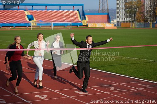 Image of business people running on racing track