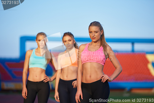 Image of athlete woman group  running on athletics race track