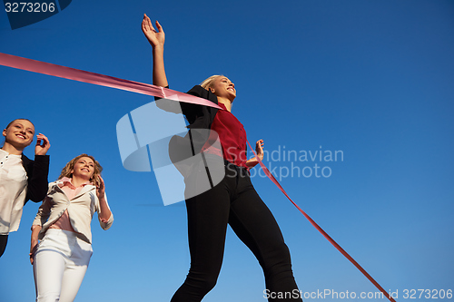 Image of business people running on racing track