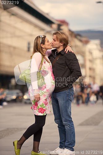 Image of young pregnant couple have fun and relax