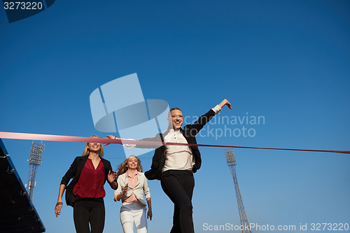 Image of business people running on racing track