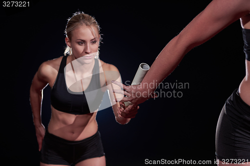 Image of athletic runners passing baton in relay race