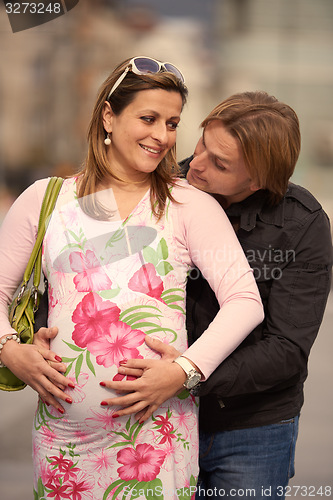 Image of young pregnant couple have fun and relax
