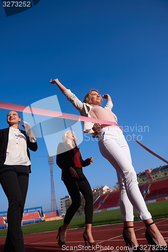 Image of business people running on racing track