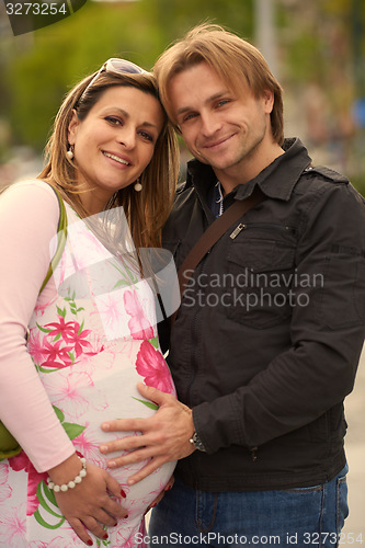 Image of young pregnant couple have fun and relax