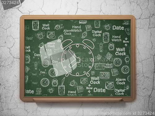 Image of Time concept: Alarm Clock on School Board background