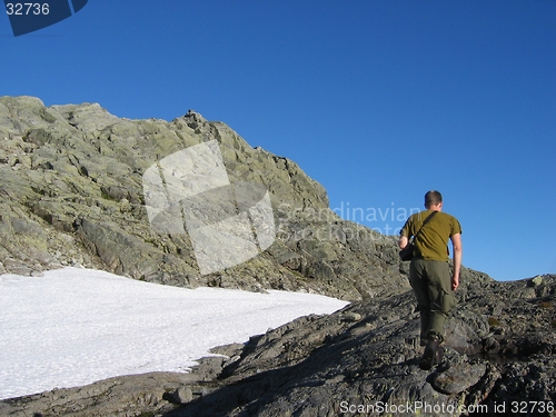 Image of Photographer tracking in mountains.