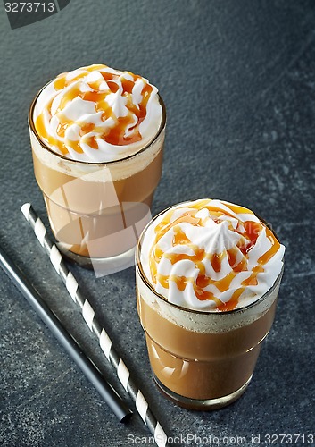 Image of two glasses of caramel latte with whipped cream