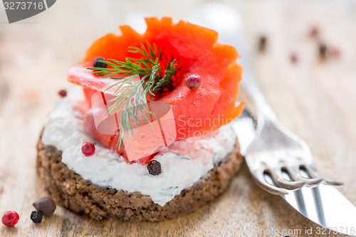 Image of Sandwich with salted red salmon and black bread.