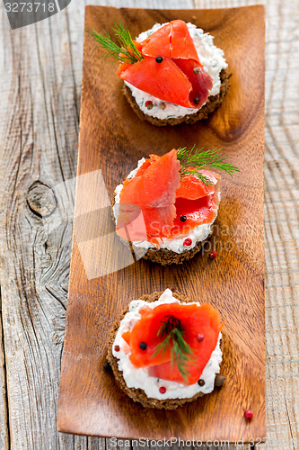 Image of Sandwiches with red salmon and dill.