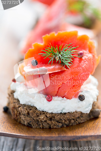 Image of Sandwich with salted red salmon close up.