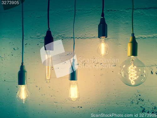 Image of Illuminated light bulbs on green background