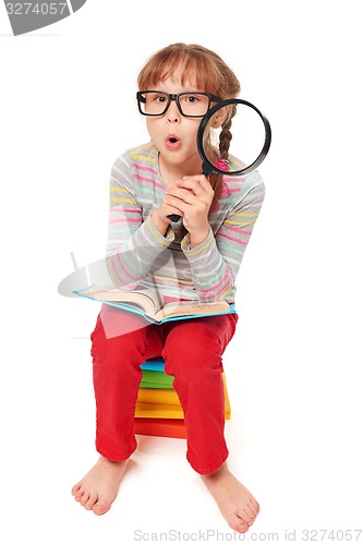 Image of Little girl sitting on floor with a lot of books