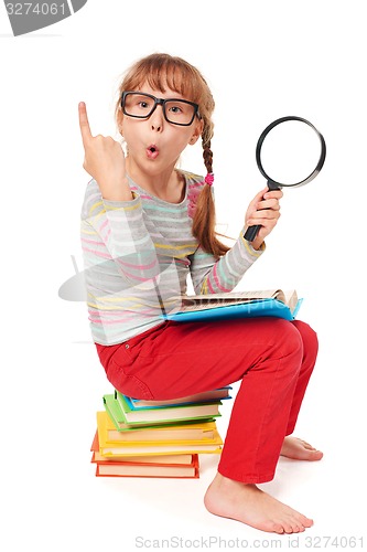 Image of Little girl sitting on floor with a lot of books