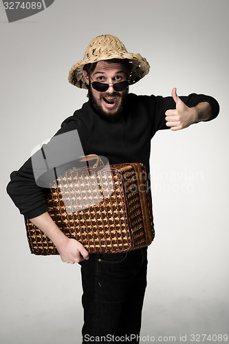 Image of Young, attractive man  in sunglasses with  suitcase ready to travel 