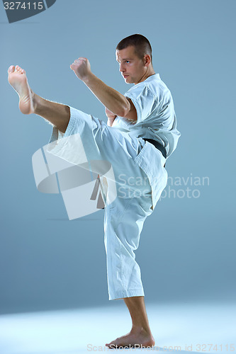 Image of Man in white kimono training karate