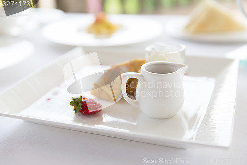 Image of close up of pancakes and honey or jam on plate