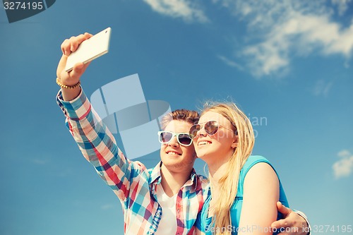 Image of smiling couple having fun outdoors