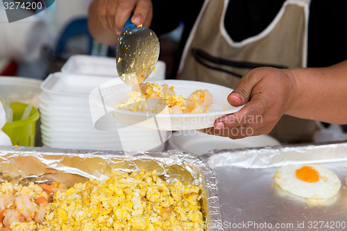 Image of close up of hands with wok at street market