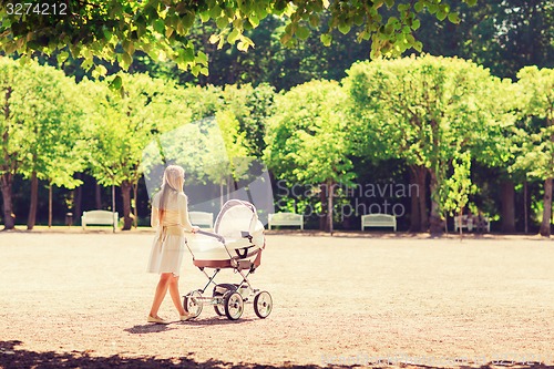 Image of happy mother with stroller in park