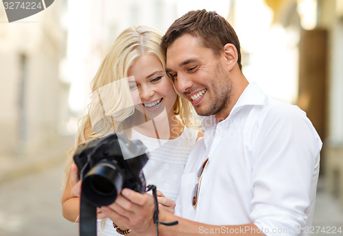 Image of smiling couple with photo camera