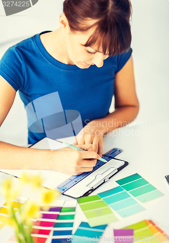 Image of woman working with color samples for selection