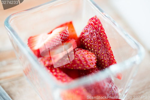 Image of juicy fresh ripe red strawberries in glass bowl