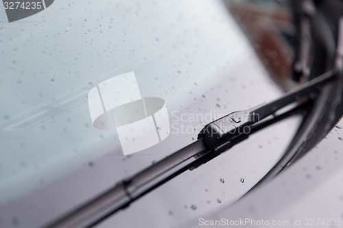 Image of close up of windshield wiper and wet car glass