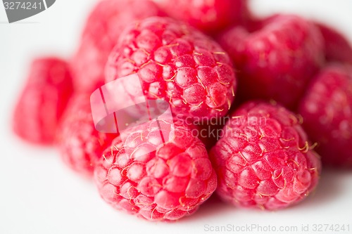 Image of juicy fresh ripe red raspberries on white
