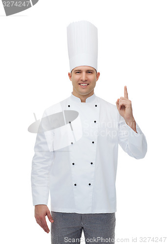 Image of happy male chef cook pointing finger up