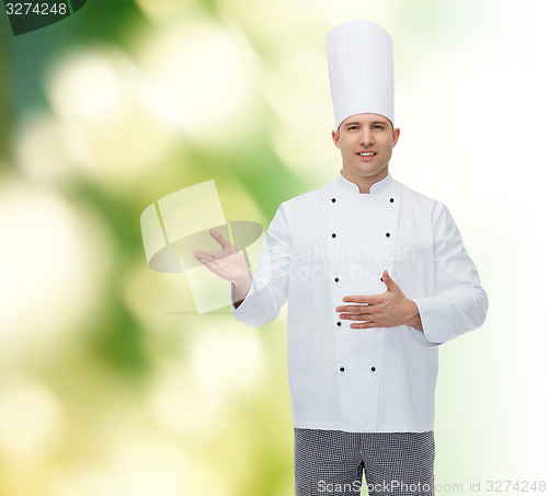 Image of happy male chef cook inviting