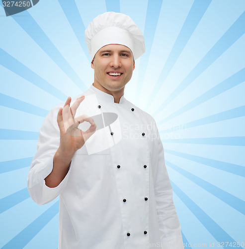 Image of happy male chef cook showing ok sign