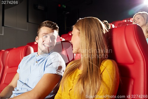 Image of happy friends watching movie in theater