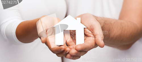 Image of couple hands with paper house