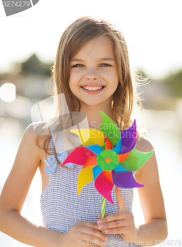 Image of happy girl with colorful pinwheel toy