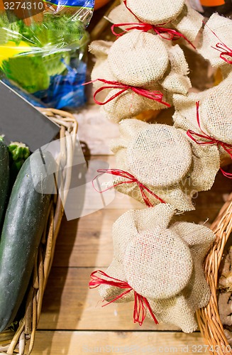 Image of honey decorated jars and vegetables at food market