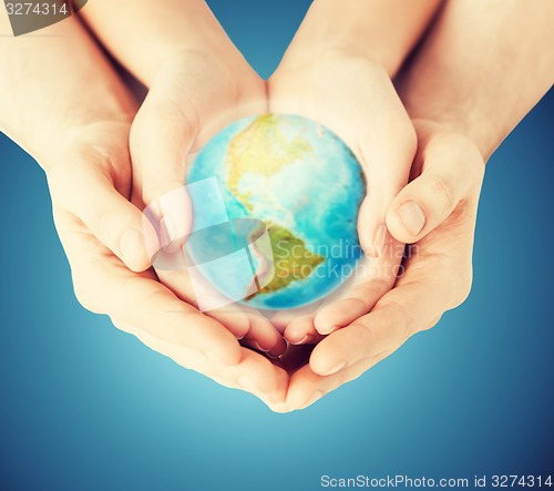 Image of close up of woman and man hands with earth globe